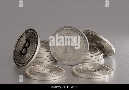 Stack of shiny silver bitcoins as example for blockchain and crypto currency spread across a metal table Stock Photo