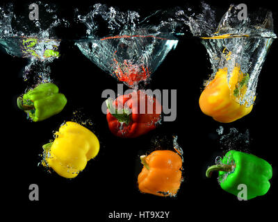 mix color bell peppers droping in to clean water Stock Photo