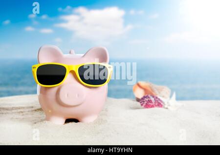 Piggy bank with sunglasses on vacation. Concept of holidays economy Stock Photo