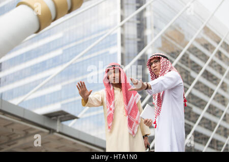 Two Arabian man making a halt gesture with he raised hand indicating a stop (selective focused) Stock Photo