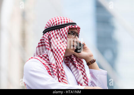 Close up portrait of Arabian man is talking phone call Stock Photo