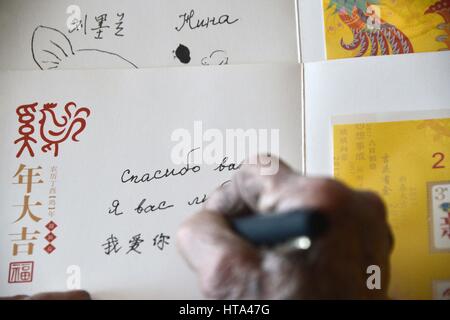 (170309) -- ZIBO, March 9, 2017 (Xinhua) -- Nina, a 91-year-old woman of Russian origin living in China, writes a greeting card to her hometown, which is in the Vologda Oblast of Russia, in Mansi River Village in Zibo City, east China's Shandong Province, March 8, 2017. Nina was born in 1926 in Vahevo Village in Vologda Oblast in northern Russia. Her father, a Chinese merchant from northern China's Hebei Province, brought her to China when she was seven. Nina's mother was Russian. Nina, whose Chinese name is Liu Molan, has spent most of her life in Mansi River Village in Zibo City. Her late hu Stock Photo