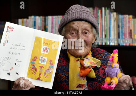 (170309) -- ZIBO, March 9, 2017 (Xinhua) -- Nina, a 91-year-old woman of Russian origin living in China, shows a card, written with greeting words to her hometown in the Vologda Oblast of Russia, in Mansi River Village in Zibo City, east China's Shandong Province, March 8, 2017. Nina was born in 1926 in Vahevo Village in Vologda Oblast in northern Russia. Her father, a Chinese merchant from northern China's Hebei Province, brought her to China when she was seven. Nina's mother was Russian. Nina, whose Chinese name is Liu Molan, has spent most of her life in Mansi River Village in Zibo City. He Stock Photo