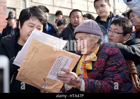 (170309) -- ZIBO, March 9, 2017 (Xinhua) -- Nina (R Front), a 91-year-old woman of Russian origin living in China, listens to a translator reading a letter from her hometown, which is in the Vologda Oblast of Russia, in Mansi River Village in Zibo City, east China's Shandong Province, March 8, 2017. Nina was born in 1926 in Vahevo Village in Vologda Oblast in northern Russia. Her father, a Chinese merchant from northern China's Hebei Province, brought her to China when she was seven. Nina's mother was Russian. Nina, whose Chinese name is Liu Molan, has spent most of her life in Mansi River Vil Stock Photo