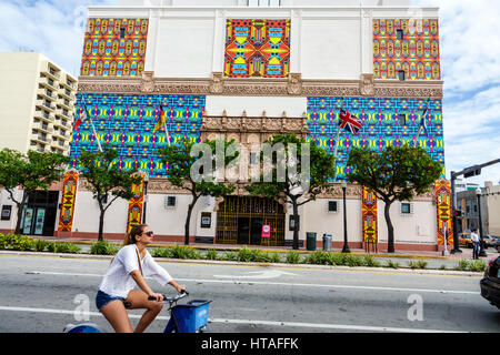 Miami Beach Florida,Washington Avenue,Wolfsonian Museum,entrance,facade,art installation,Christie van der Haak,woman female women,riding,bicycle,FL170 Stock Photo