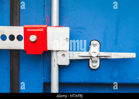 Gate valve and lock of standard blue cargo shipping container Stock Photo