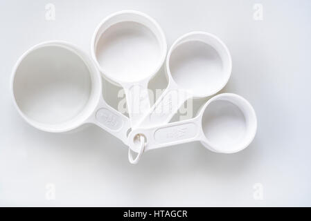 Four plastic measuring cups baking cooking measurement equipment Stock Photo