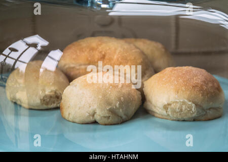 Home baked bread rolls on a glass topped cake stand. Stock Photo