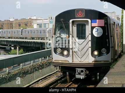 The Q elevated subway express train pulling into the Brighton Beach station in Brooklyn, New York. Stock Photo