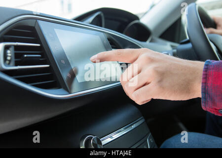Close Up Of Driver Using Touchscreen In Car Stock Photo
