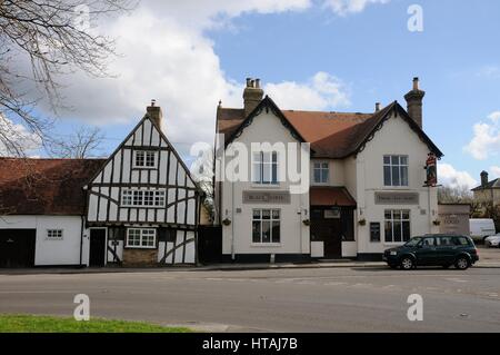 Bolbec Cottage which  is dated 1587, and The Black Horse inn which proclaims on its walls ‘Drink – Eat - Sleep’,  Swaffham Bulbeck, Cambridgeshire Stock Photo