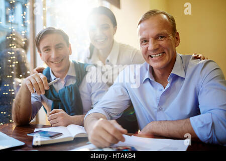 Team of friendly employees smiling at camera Stock Photo