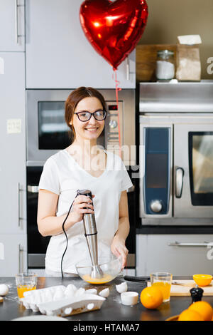 Young woman cooking breakfast for her sweetheart Stock Photo