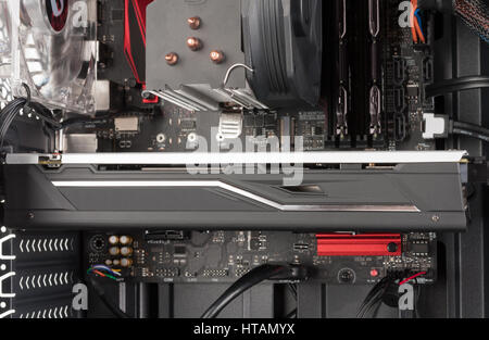 Close up of graphics card in PCIe slot on ATX motherboard on open computer case Stock Photo