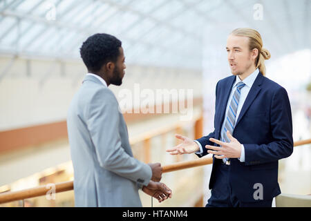 Two young entrepreneurs consulting in formal environment Stock Photo