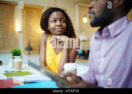 Two young entrepreneurs having business talk in cafe Stock Photo