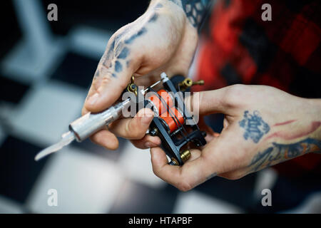 Device for making tattoo in human hands Stock Photo
