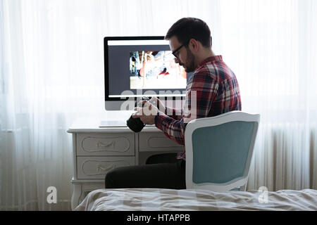 Photographer retoucher working on photos and editing on desktop Stock Photo