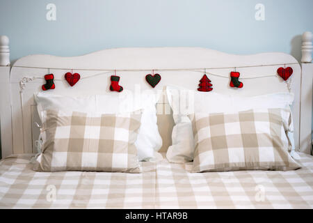 Beautiful Christmas decor and comfortable bed in bedroom. Interior ...