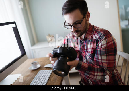 Photographer retoucher working on photos and editing on desktop Stock Photo