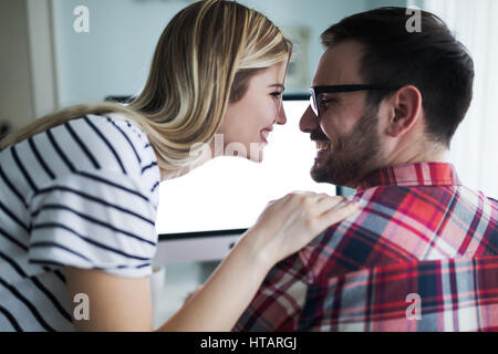 Supportive woman caring for husband working from home Stock Photo