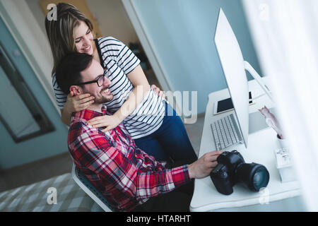 Couple in love working from home on design project Stock Photo