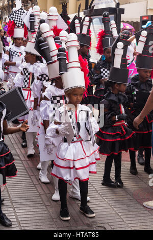 The colorful Children's Carnival Parade in the historic Old Colonial City of Santo Domingo, Dominican Republic.  A UNESCO World Heritage Site. Stock Photo