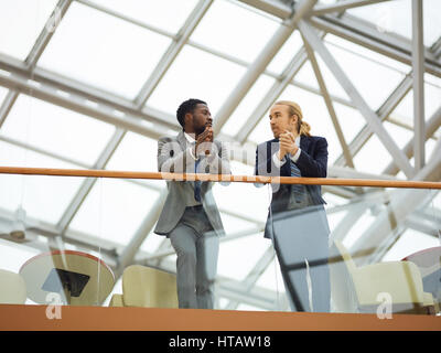 Young multi-ethnic entrepreneurs talking at meeting Stock Photo