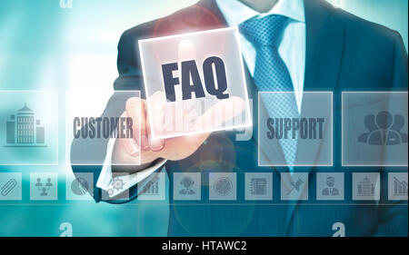 A businessman selecting a Frequently Asked Questions Concept button on a clear screen. Stock Photo