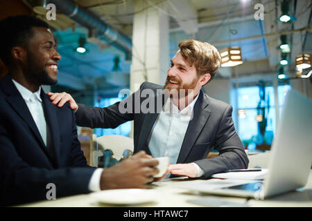 Two co-workers having friendly talk at break Stock Photo