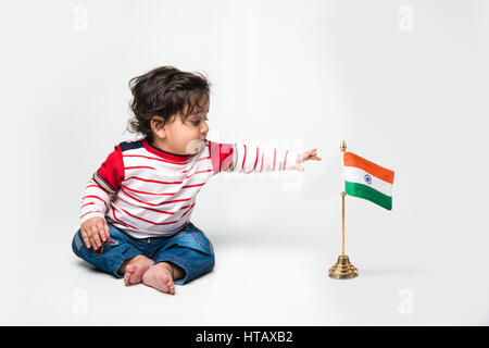 Indian baby boy playing over over white background and looking at camera Stock Photo