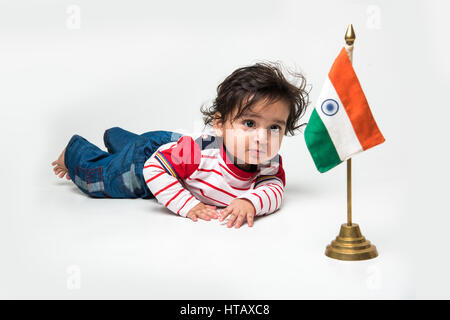 Indian baby boy playing over over white background and looking at camera Stock Photo