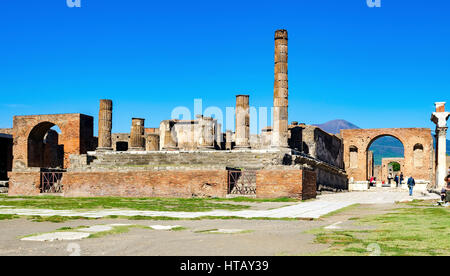 Forum and Temple of Jupiter with sulbackground Vesuvius in ancient Pompeii. It was completely destroyed by the eruption of Mount Vesuvius. One of the  Stock Photo