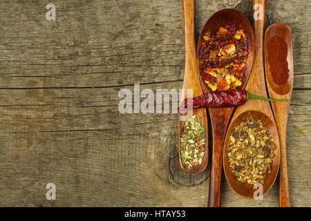 Dried chili peppers on a wooden spoon. Sale of spices. Advertising for sale. Different kinds of hot peppers Stock Photo