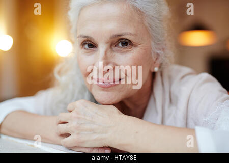Happy grey-haired female smiling at camera Stock Photo