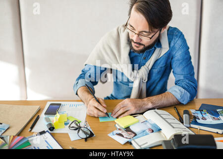 Professional designer writing plan of work Stock Photo