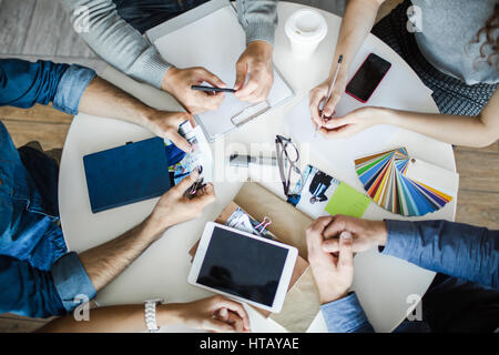 Top view of hands of designers during planning work or brainstorming Stock Photo