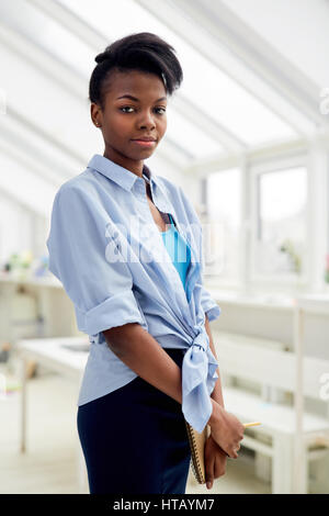 Young specialist with notepad working in studio Stock Photo