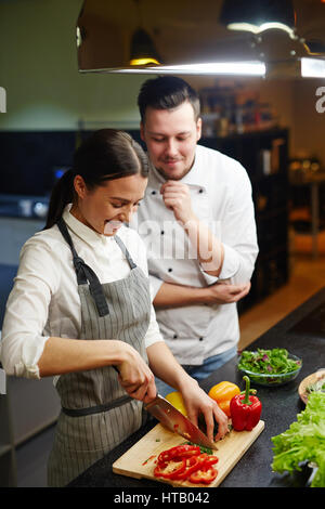 Girl cooking slow food with chef near by Stock Photo