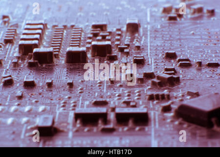 Surface-mount dusty smd components on used electronic circuit board close-up. Stock Photo