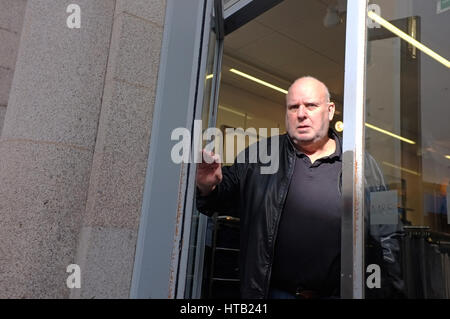 Man walking through door. Stock Photo