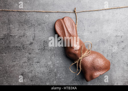 Delicious traditional Easter chocolate bunny hanging on a string Stock Photo