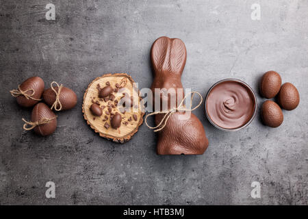 Delicious chocolate Easter bunny and eggs on wooden background Stock Photo