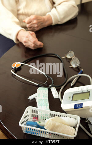 Medical Devices are on the table.  Hands of the old woman on a table. Stock Photo