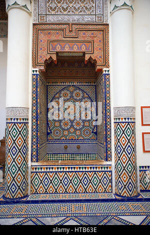 Berber Arabesque Morcabe plasterwok Zellige tiles of a fountain in the Marrakesh museum in the Dar Menebhi Palace, Marrakesh, Morocco Stock Photo