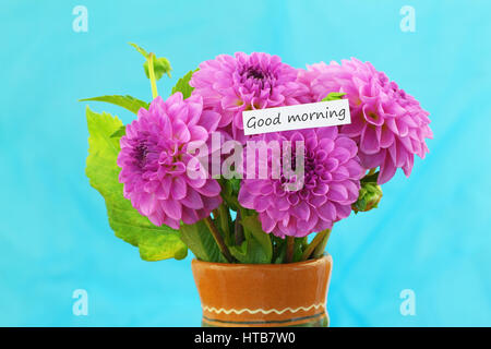 Good morning card with bouquet of pink dahlias on vivid blue background Stock Photo