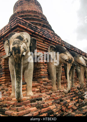 Elephant statues built into the ruins of a Buddhist stupa at Sukhothai Historic Park in Thailand. Stock Photo