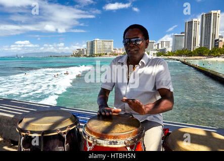 Waikiki Beach, Hawaii, USA - August 2, 2016: Musician and conga drummer Rico Davis entertains tourists and locals in Hawaii. Stock Photo