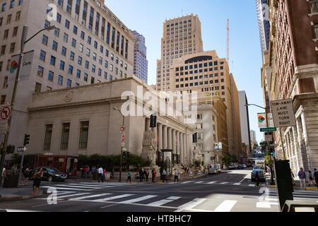 People cross Sansome Street, with the former Pacific Coast Stock Exchange building visible, in the Financial District neighborhood of San Francisco, California, September 26, 2016. Stock Photo