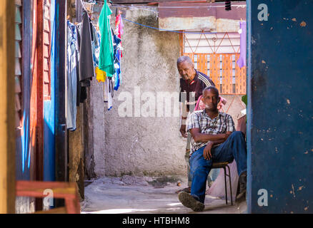 Santiago de Cuba, Cuba on January 5, 2015: Cuban people in colorful house with clothes Stock Photo